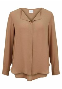 Blusa a maniche lunghe in morbido e leggero tessuto marrone. Caratterizzata da una scollatura a V e un orlo curvo. Texture liscia con una leggera drappeggiatura.