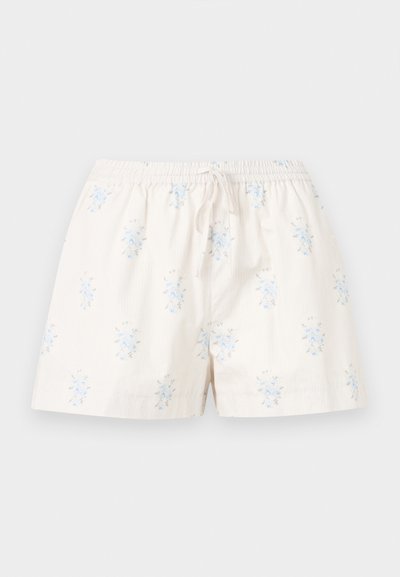 Shorts beige clair avec petits motifs floraux bleus, taille élastique et cordon de serrage à l'avant pour ajustement.