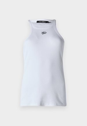 Débardeur blanc à côtes avec un col haut et sans manches. Présente un petit logo noir de Karl Lagerfeld au centre. Tissu texture doux.