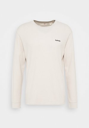 Lys beige langærmet T-shirt med V-hals, ribbet tekstur og et lille sort "Levi's" logo på venstre bryst.