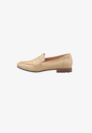Beige læder loafer med syet tå, minimalistisk design og lavt træsko. Flad sål med en subtil sort og rød accent.