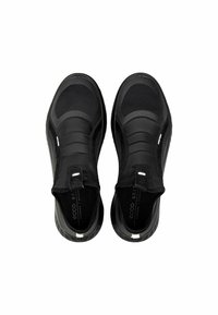 Black slip-on shoes featuring a smooth textile upper, a cushioned sole, and elastic bands for fit. Minimalist design with no visible branding.