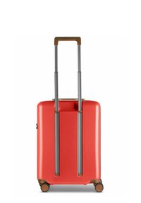 Hard-shell suitcase in vibrant red with a smooth surface, dual silver extendable handles, and four brown rolling wheels for mobility.