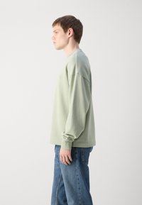 HUGO NINNYO - Felpa - light pastel green
