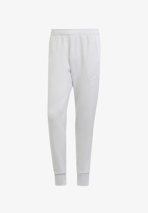 Lichtgrijze sportbroek met een elastische tailleband, taps toelopende benen, zijzakken en een geborduurd driehoekig logo op het onderbeen.