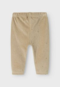 Leggings per bambini in velluto beige con vita elasticizzata, dotati di piccole macchie dorate distribuite uniformemente su tutto il tessuto.