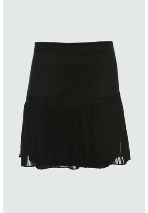 Black skirt with lace upper section and pleated sheer fabric lower section, knee-length with a scalloped trim separating the two textures.