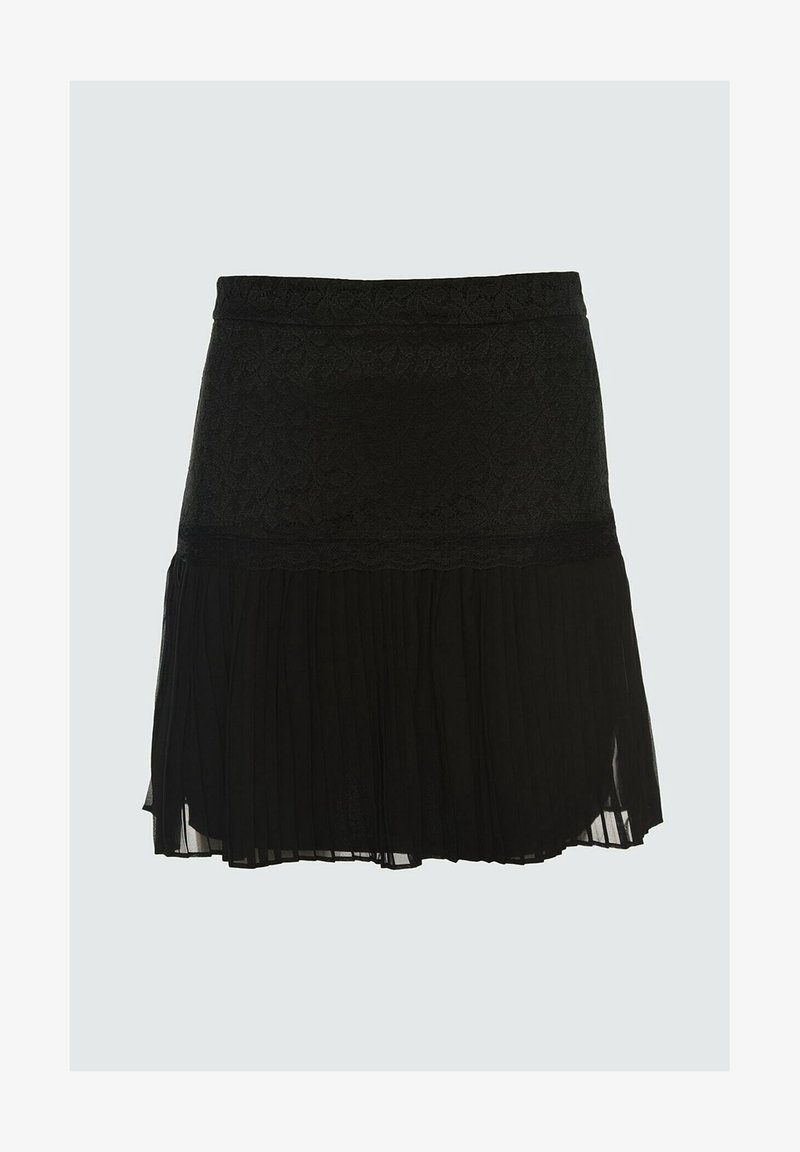 Jupe noire avec partie supérieure en dentelle et partie inférieure en tissu transparent plissé, longueur genoux avec un volant festonné séparant les deux textures.