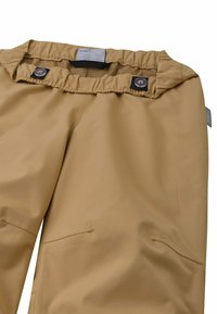Beige wasserdichte Hose mit gerafftem Bund, zwei Knöpfen, sichtbaren Nähten und flachen Fronttaschen. Glatte Textur und funktionales Design.