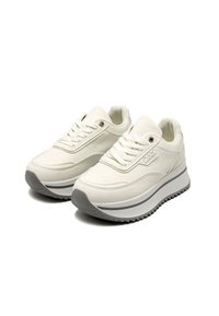 Sneakers platform bianche con motivi in rilievo, allacciatura frontale e suole in gomma grigia, angolate per mostrare entrambe le scarpe su sfondo bianco.