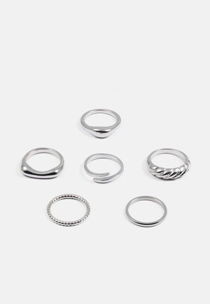 Set of six silver rings featuring various designs: smooth, twisted, beaded, and open styles, all with reflective, polished surfaces.