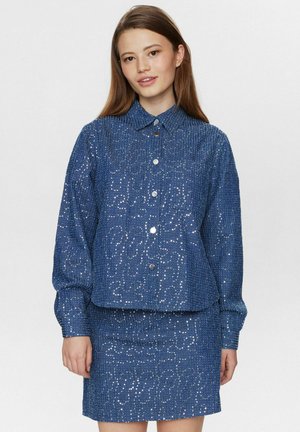 Blue denim jacket with a textured surface and sequins, featuring a collared neckline and front buttons, paired with a matching skirt.