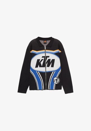 Cardigan nero a maglia con zip, caratterizzato da un prominente logo KTM, strisce blu e arancioni, e una toppa circolare sull'orlo.