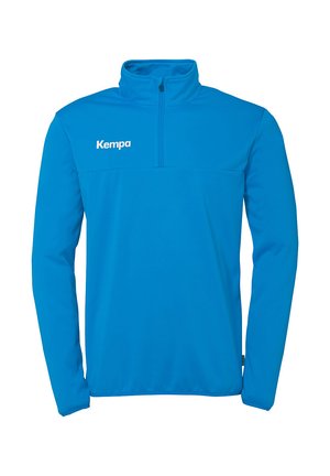 Blauwe atletische pullover van soepele synthetische materiaal, met een half-rits kraag en het merkimago "Kempa" op de bovenste linkerzijde.