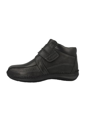 Black leather ankle boot with Velcro strap, rounded toe, contrasting stitching, and a sturdy outsole. Slightly padded collar for comfort.