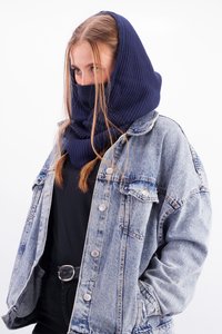 Navy knitted hood scarf worn with a light blue denim jacket over a black top, featuring a large hood and textured fabric.