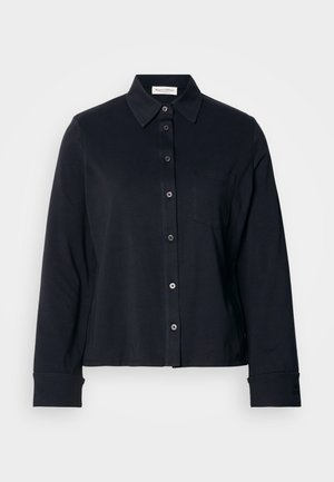 Black cotton shirt with a buttoned front, collar, long sleeves, and a chest pocket. Features a smooth texture and structured design.
