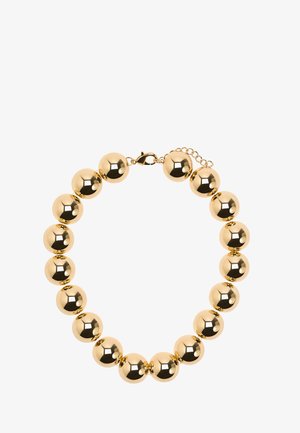 Bransoletka w kolorze złota z dużymi, polerowanymi okrągłymi koralikami połączonymi małymi ogniwami i zapięciem typu karabińczyk z regulowanym łańcuszkiem.