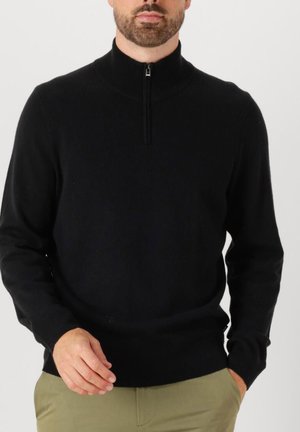 Schwarzer Zip-Hals-Pullover aus glattem Material. Figurbetonter Schnitt mit langen Ärmeln, ausgestattet mit einem kurzen Reißverschluss und einem gerippten Kragen.
