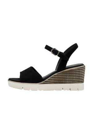 Black wedge sandal with a suede finish, open toe, adjustable ankle strap, and patterned gold and white wedge heel. Rubber sole for grip.