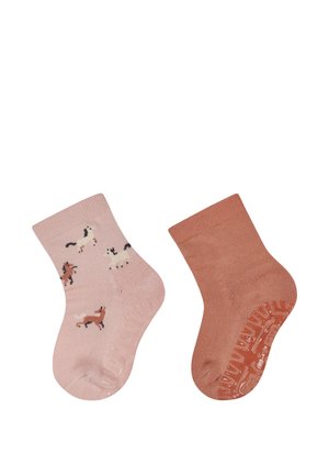 Paar Kleinkind-Socken, eine hellrosa mit Pferdemustern, die andere in einfarbigem Rostrot, beide mit rutschfesten Sohlen ausgestattet.