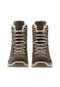 Bruine suède wandelschoenen met witte nepbontvoering, beige zolen en beige veters. Voorzien van metalen veterogen en een verstevigde hiel voor duurzaamheid.