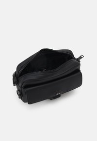 Borsa in pelle nera testurizzata con chiusura a zip, caratterizzata da una tasca interna e una forma rettangolare piatta. Include un cursore della cerniera come accessorio.