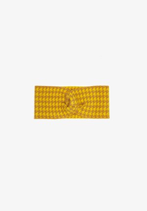 Fascia per capelli lavorata a maglia gialla con un motivo a zigzag. Presenta un dettaglio a nodo centrale e una texture morbida. Misura circa 22 cm di lunghezza.