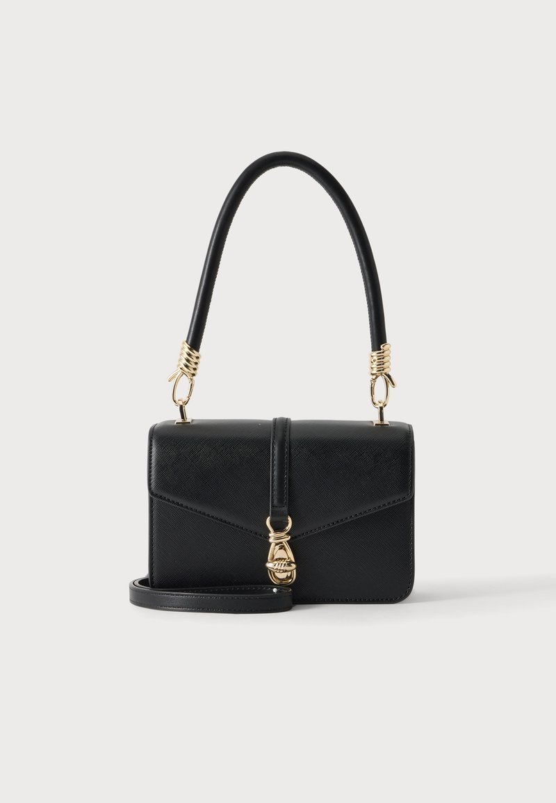 Sac à main en cuir noir avec fermoir et accessoires dorés, poignée courte incurvée, et une longue bandoulière amovible sur un fond uni clair.