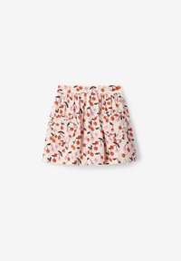 Jupe florale avec une base beige clair, ornée d'un imprimé cerise en rouge et rose. Taille froncée et deux poches en forme de cœur à l'avant.