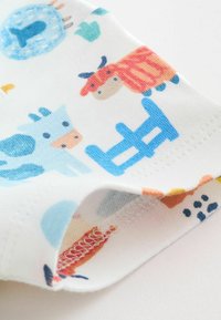 Pamut szövet, színes állatminta kék tehenekkel, piros macskákkal és különböző alakzatokkal fehér alapon. Szegély látható varrással.