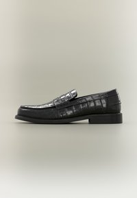 Black leather loafers with a glossy croc-embossed finish, flat sole, and simple strap detailing. Rounded toe and low-profile design.
