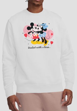 Person wearing white sweatshirt with Mickey and Minnie Mouse hugging and pink hearts, text below reads "sealed with a kiss."