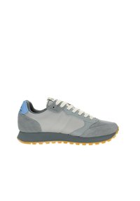 Sneaker grigio con una combinazione di texture liscia e scamosciata. Presenta lacci bianchi, un accento blu chiaro sul tallone e una suola in gomma.