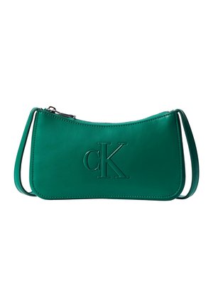 Green leather shoulder bag with embossed "cK" logo and top zipper closure, featuring a slim adjustable strap.
