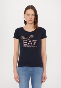 Tamsiai mėlynas trumpų rankovių T-shertas iš medvilnės audinio, su daugiakadrėmis tekstinėmis logotipais "EA7" ir "Emporio Armani", atspausdintais priekyje.