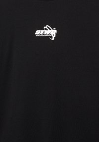 Black cotton t-shirt featuring a white graphic logo with a planetary design and text, located on the upper left side. Short sleeves, crew neck.
