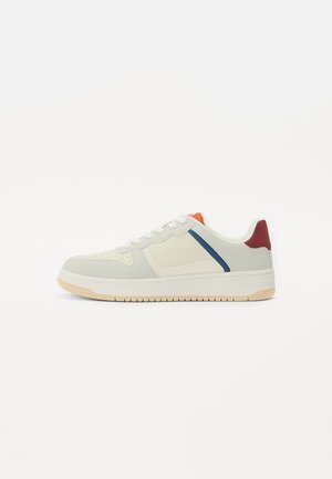 Sneaker with a white and light grey upper, featuring orange, navy blue, and burgundy accents, textured materials, and a beige rubber sole.