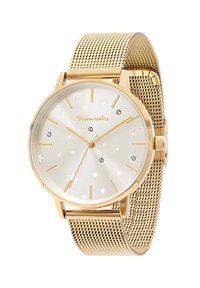 Montre à bracelet en maille dorée avec un cadran rond argenté portant des motifs d'étoiles et des accents ressemblant à des diamants, des aiguilles dorées et un détail de logo.