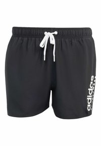 Crne kupaće hlače od lagane tkanine, s bijelom vezicom i ispisanom "adidas" logotipom u bijeloj boji sa strane.