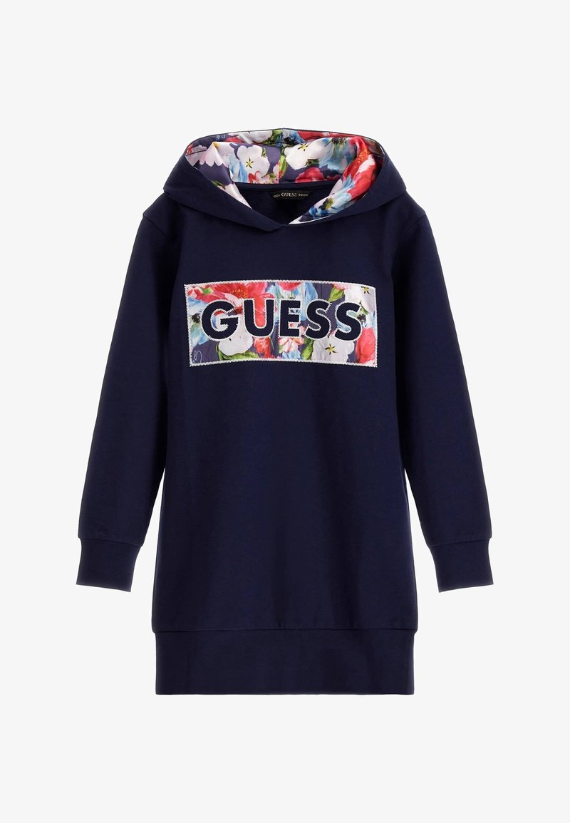 Sweat-shirt à capuche bleu marine avec une doublure intérieure à motif floral. Présente un grand logo "GUESS" sur le devant. Matière douce, manches longues, poignets côtelés.