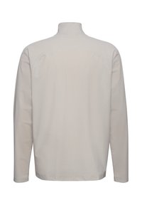 Hellbeige Pullover mit langen Ärmeln und hohem Kragen, aus strukturiertem Stoff und mit Flatlock-Nähten. Schlankes, minimales Design mit gerader Schnittform.