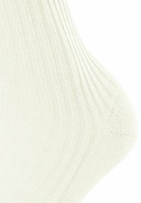 Calzini a coste di colore crema chiaro con una texture morbida, finitura liscia e punte e talloni rinforzati per una maggiore durata.