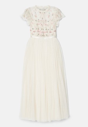 Elfenbensfarvet kjole med en gennemsigtig, broderet bodice, der har blomster mønstre. Plisseret, fuld nederdel lavet af letvægtsstof. Har flæser på ærmerne.