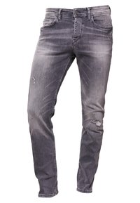 Szare dżinsy z denimu o wyblakłym wykończeniu, zwężanym kroju, delikatnymi przetarciami na kolanie, tradycyjnymi pięcioma kieszeniami i zapięciem na metalowy guzik.