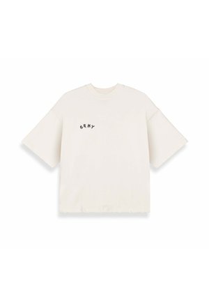 Hellbeige übergroßes T-Shirt aus Baumwolle, mit kurzen Ärmeln und einem kleinen schwarzen "GRNY"-Logo auf der linken Seite.