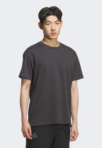 Dark gray cotton t-shirt with a round neckline and short sleeves. The fabric appears smooth, with no visible patterns or accents.