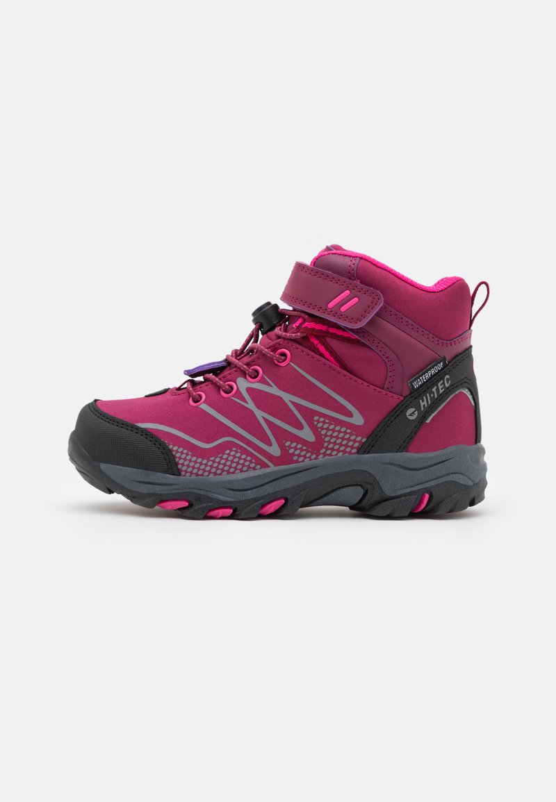 Mid-cut hiking boot in dark pink and gray. Features a waterproof design, adjustable strap, and textured sole with pink accents.