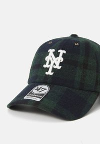Grønn rutete baseballcaps laget av ull, med hvit brodert logo, justerbar stropp og rund merkelapp på skyggen for størrelsesdetaljer.