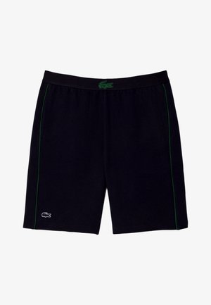 Čierne športové šortky s zelenými bočnými pruhmi, elastickým pásom a zeleným logom krokodíla uprostred a bielym logom krokodíla na ľavej nohe.